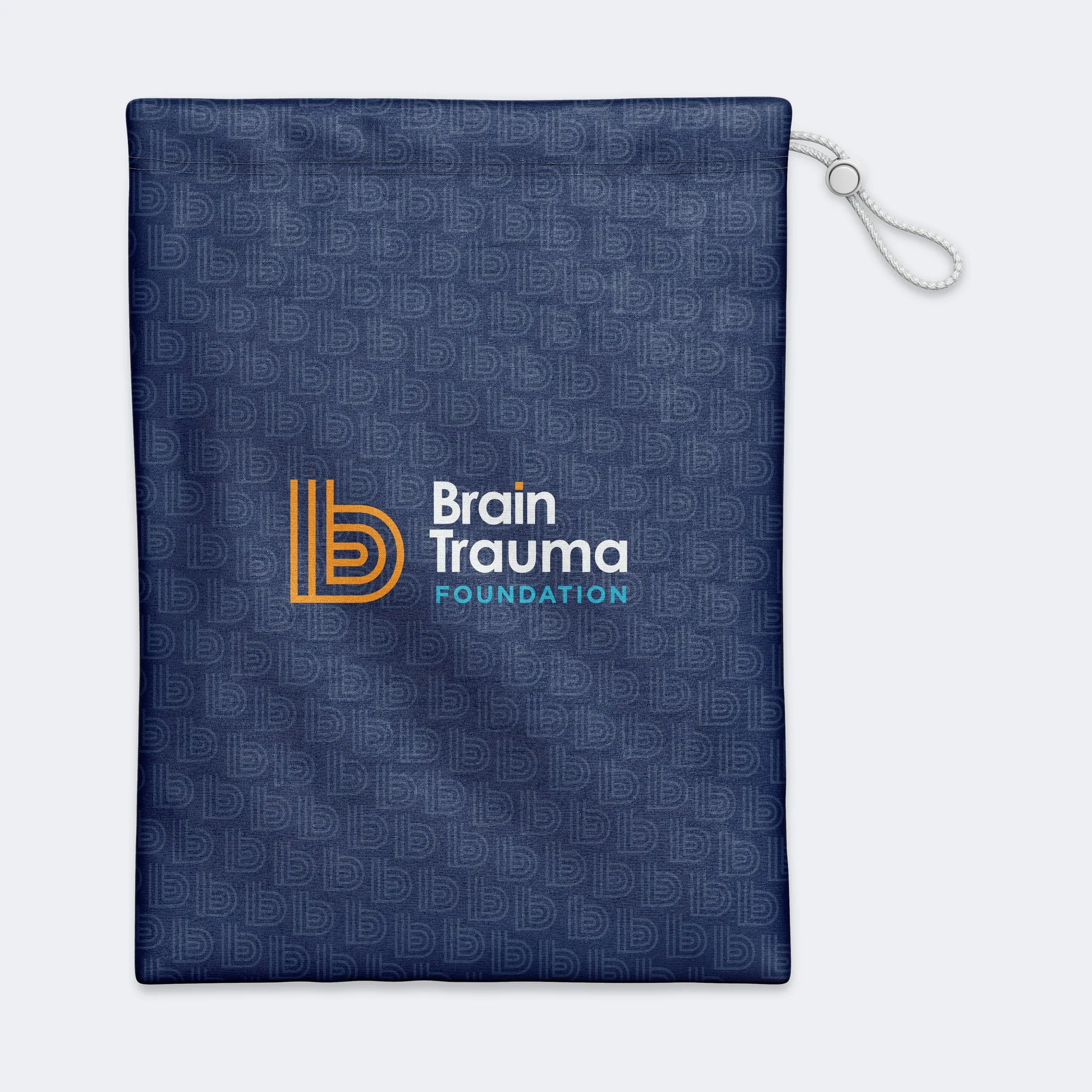 A navy denim drawstring bag with the Brain Trauma Foundation logo