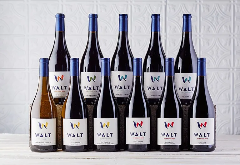 Eleven WALT bottles in two rows, each W in its region’s color